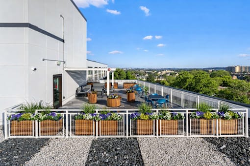 A patio with a white fence and a black and white striped area in front of it.