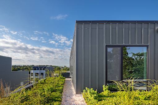 A modern house with a grey exterior and a large window.