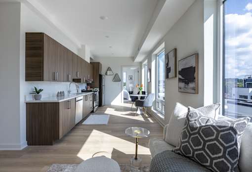 A modern kitchen with a dining area and a living room.