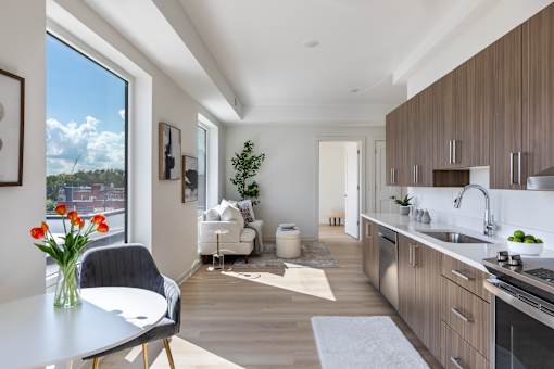 A modern kitchen with a dining table and chairs.