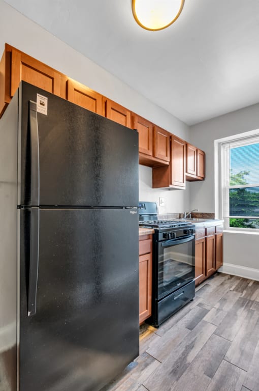 a kitchen with stainless steel appliances and wooden cabinets