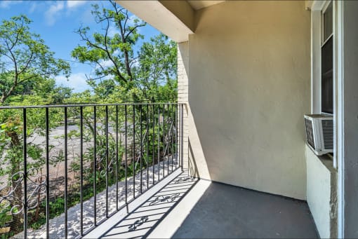 a balcony with a view of a river and trees