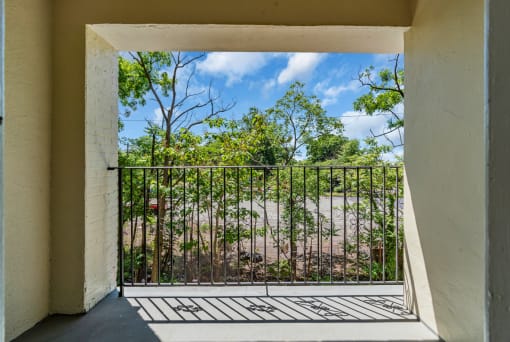 a view of the river from a balcony with a gate