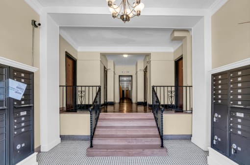 a large hallway with a staircase and a chandelier    and doors