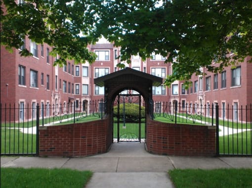 the entrance to an apartment building with a wrought iron gate