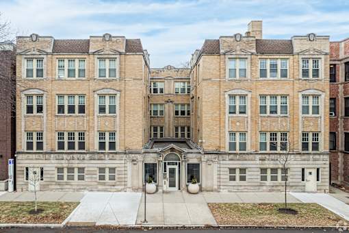 A large, two-story building with a central entrance and a symmetrical facade.