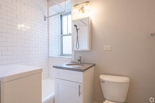 A white bathroom with a toilet, sink, and tub.