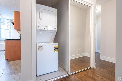 A white fridge with a yellow sticker on it.