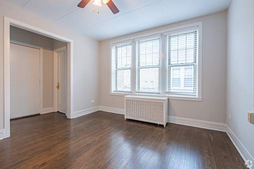 A room with a window and a fan.