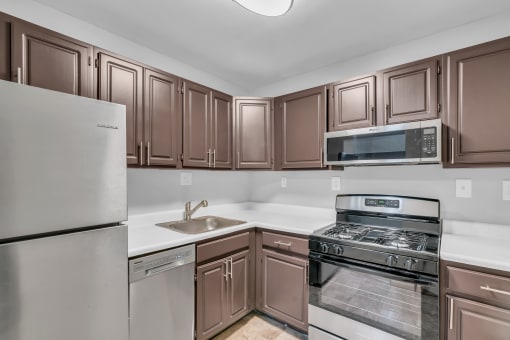 a kitchen with stainless steel appliances and wooden cabinets