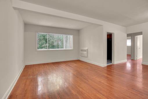 A room with wooden floors and white walls.