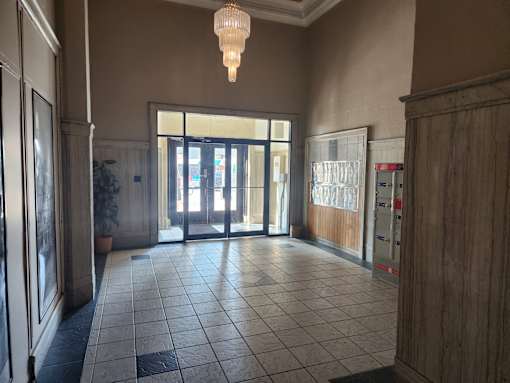 A hallway with a chandelier hanging from the ceiling.
