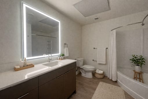 A bathroom with a white countertop and a large mirror.