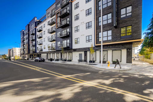 A street view of a residential area with apartment buildings.