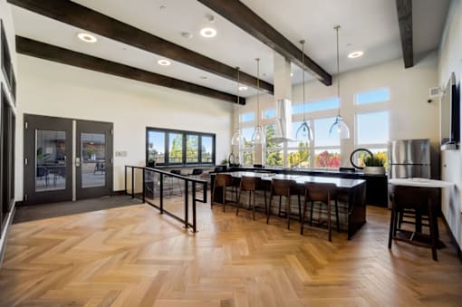 A modern kitchen with wooden floors and a large island.