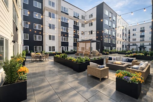 A courtyard with a table and chairs surrounded by buildings.