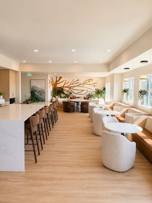 A modern dining area with a long table and chairs.