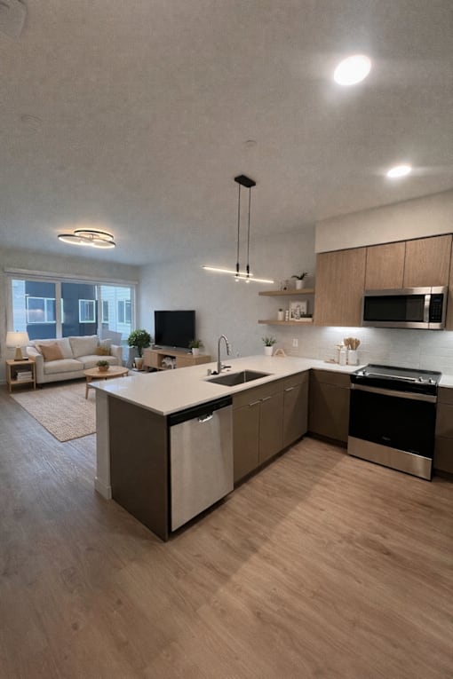 A modern kitchen with a large island and a microwave above it.