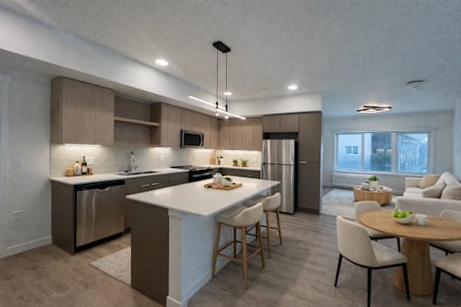 A modern kitchen with a dining table and chairs.