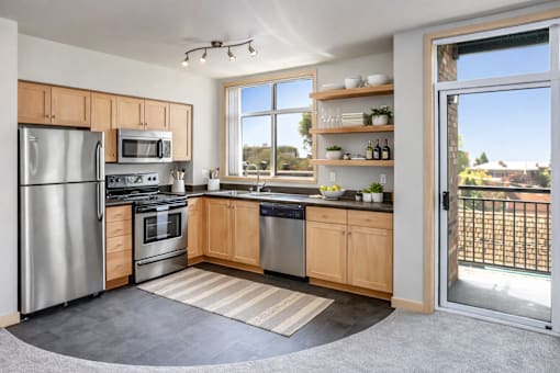A modern kitchen with stainless steel appliances and wooden cabinets.