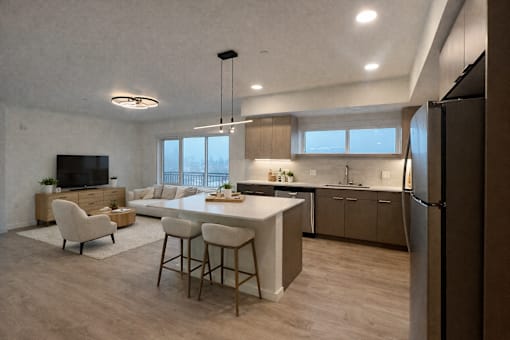 A modern kitchen with a bar area and a television.