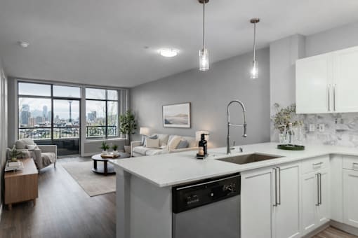 A modern kitchen with white cabinets and a large island.