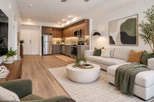 A modern living room with a grey couch and a coffee table.