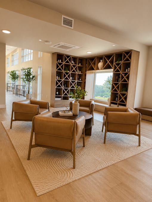 A living room with a large table surrounded by chairs and a wine rack in the background.