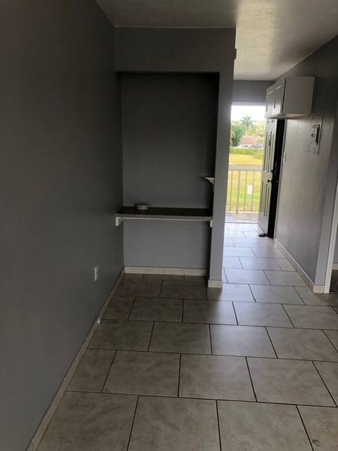 A room with grey walls and a closed door.