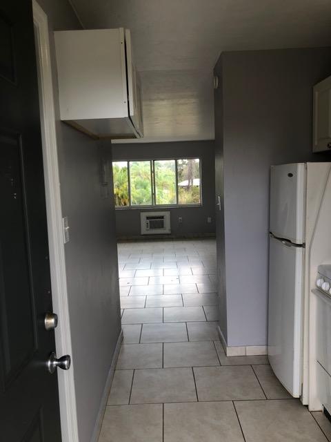 A room with a white cabinet and a black countertop.