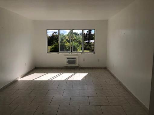 A room with a large window and tiled floor.