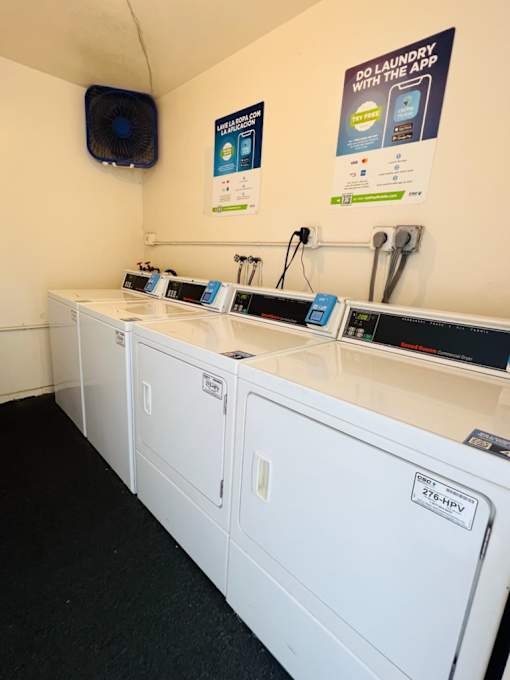 A row of washing machines in a laundromat.