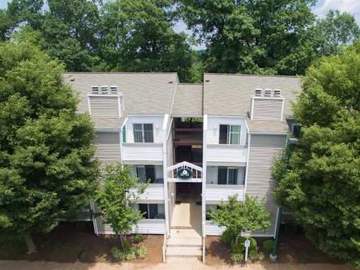 A two-story apartment building with a small courtyard in the middle.