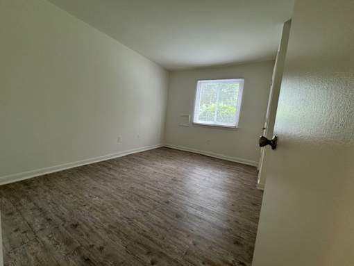 A room with a window and a door.