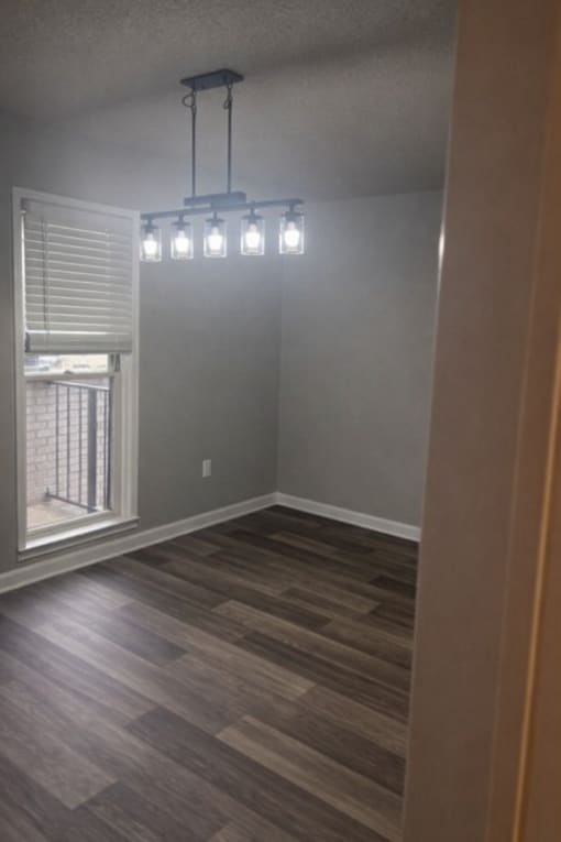 A room with a window and a light fixture.