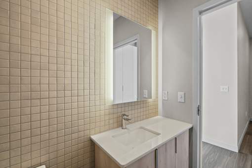 A bathroom with a sink and a mirror.