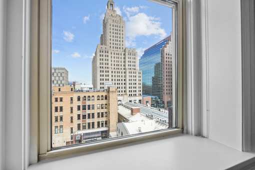 A view of a cityscape through a window.