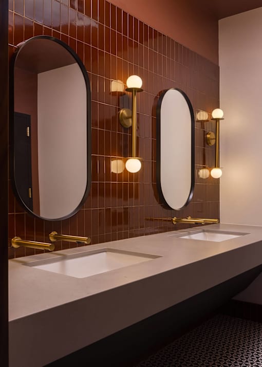 A bathroom with two sinks and two mirrors.