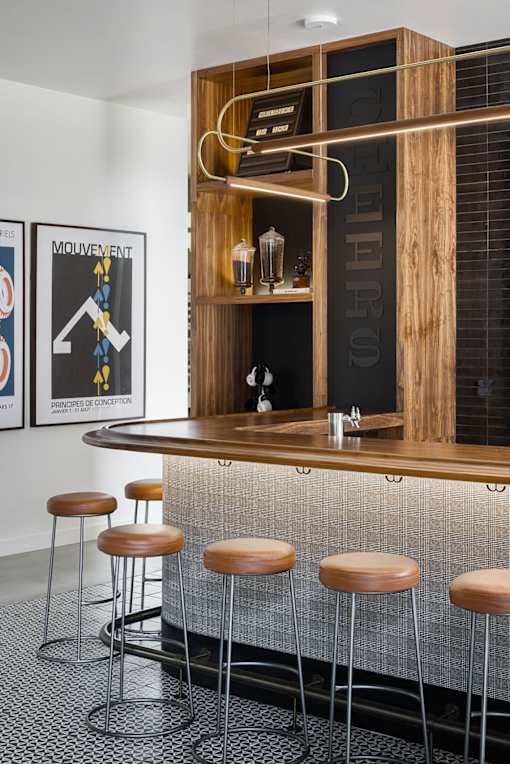 A bar with a wooden shelf and a black and white poster on the wall.