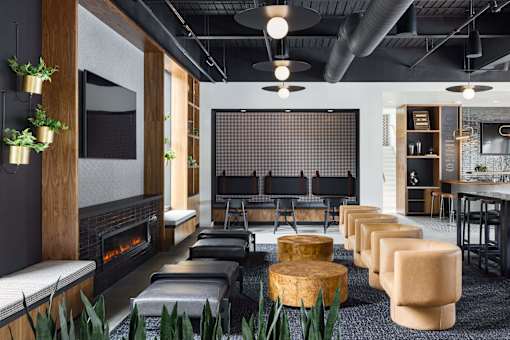 A modern living room with a fireplace and a large screen TV.