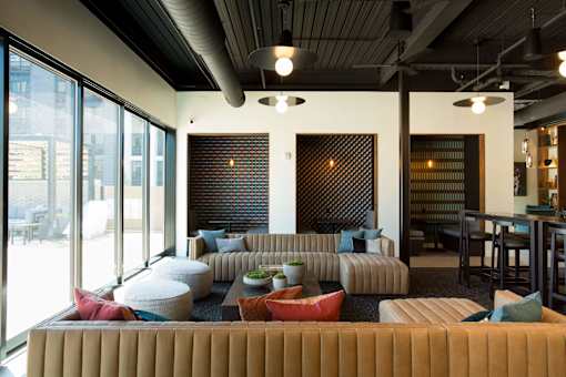 A modern living room with a large sectional sofa and a fireplace.
