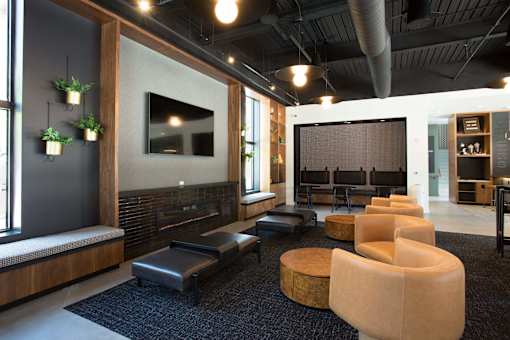 A modern living room with a fireplace and a large screen TV.