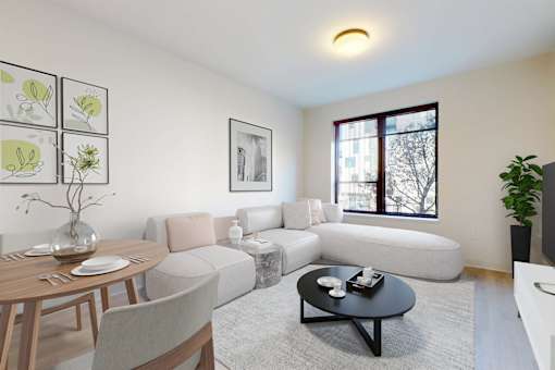A living room with a grey sofa, a wooden table, and a black coffee table.