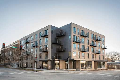 A modern building with a mix of balconies and windows.