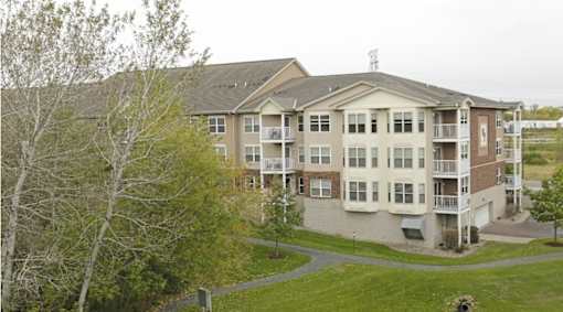 Apartment complex with a green lawn in front.