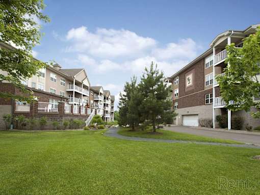 Apartment complex with green grass in front.