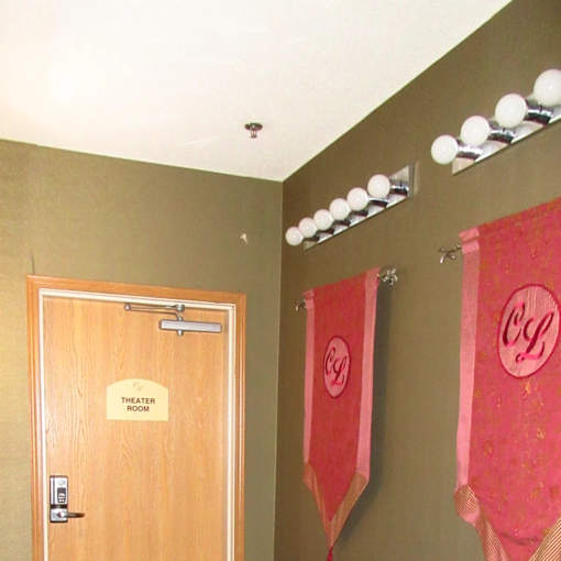 A brown door with a sign that says "theater room" on it.
