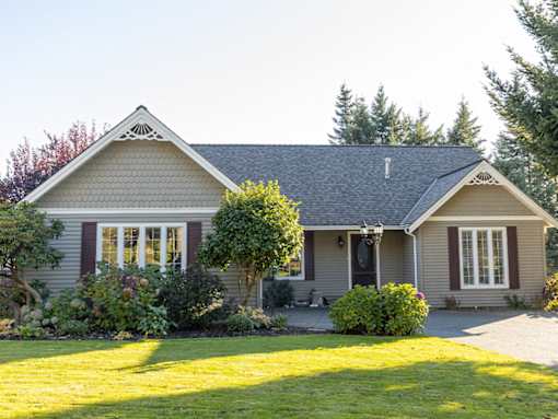 A house with a grey roof and a white window.