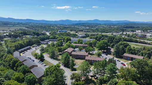 A bird's eye view of a residential area with houses and cars.