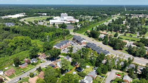 An aerial view of a residential area with a large building in the distance.